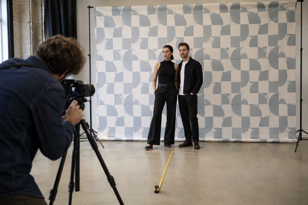 Photographer tests patterned backdrop with models